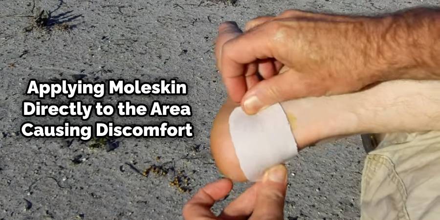Applying moleskin to the area causing discomfort