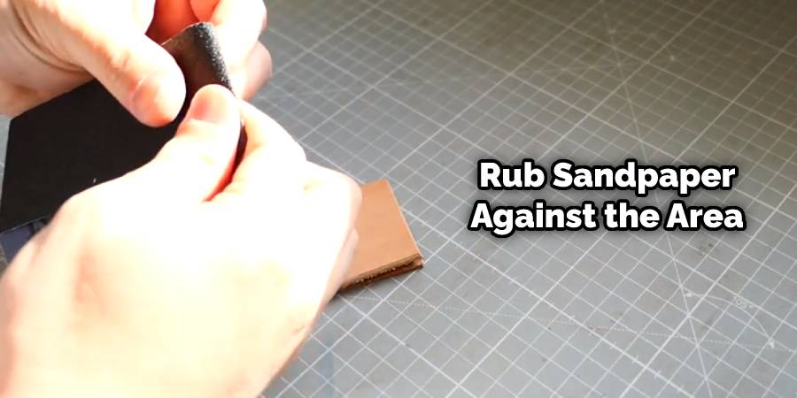 Rub sandpaper against the area