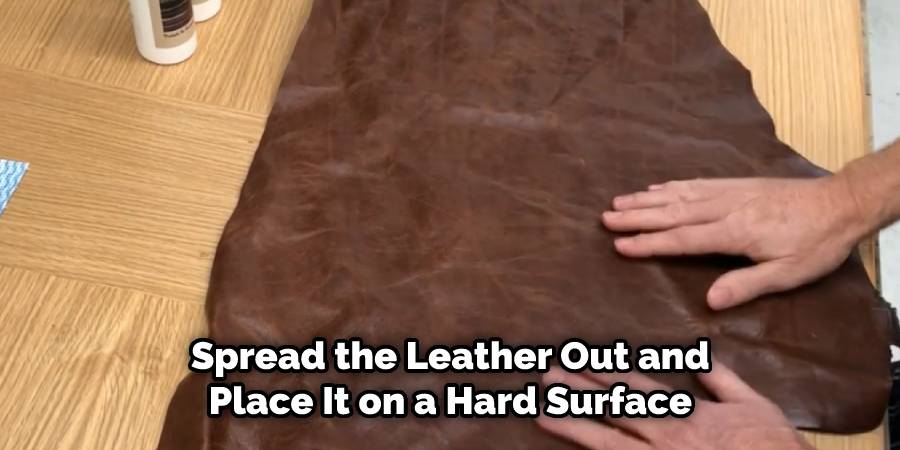Spread the leather out on a hard surface