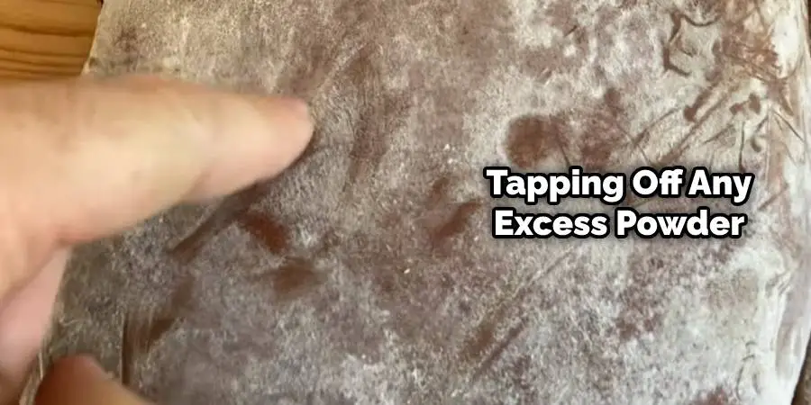 Tapping Off Any Excess Powder