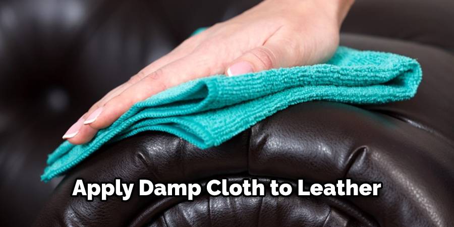 Apply damp cloth to leather