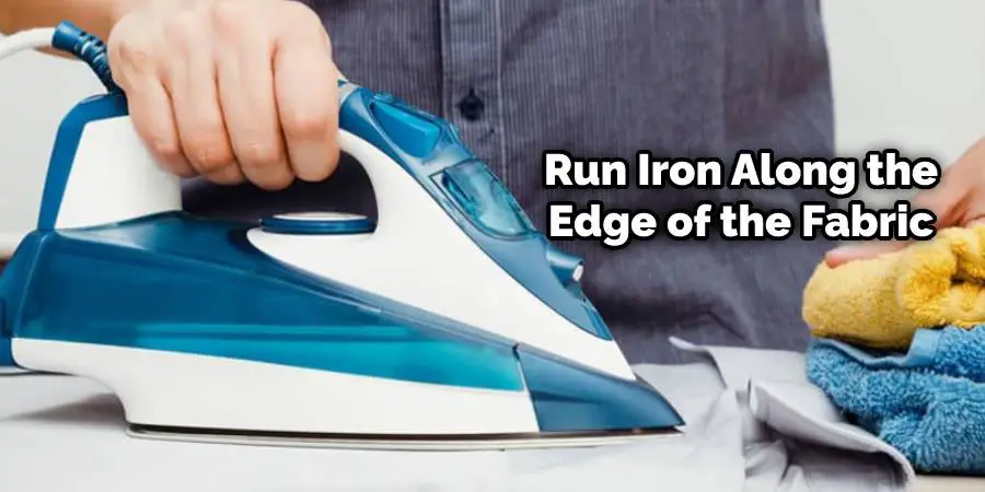 Run iron along the edge of the fabric