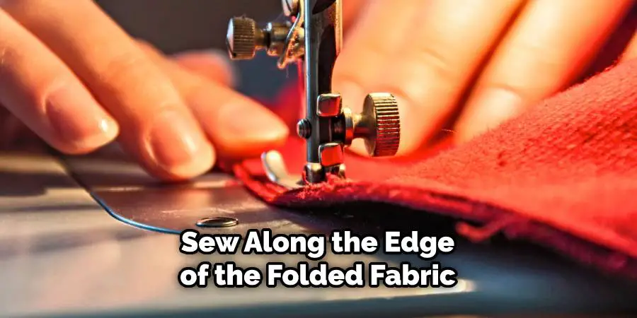 Sew along the edge of the folded fabric