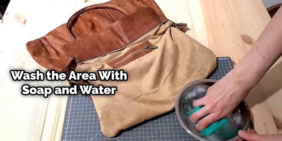 Wash the area with soap and water