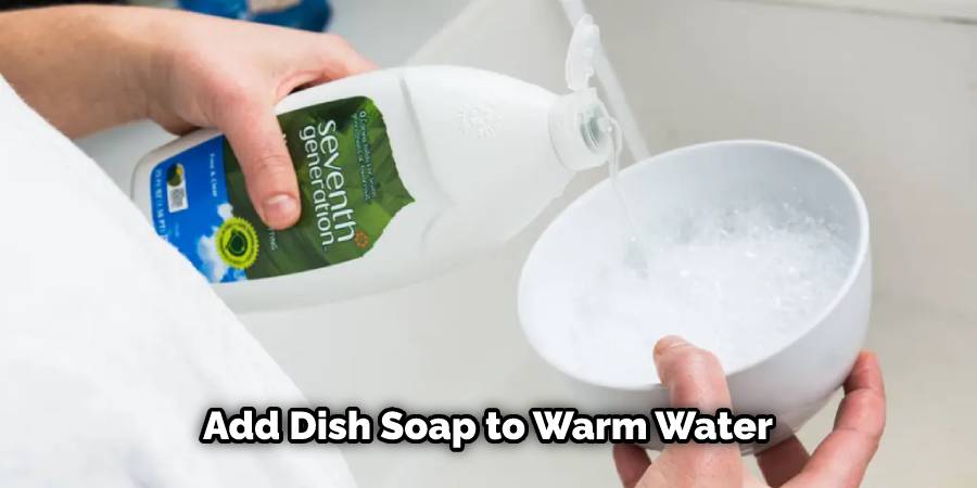 Add dish soap to warm water