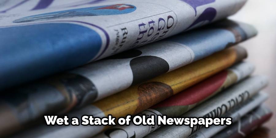 Wet a stack of old newspapers