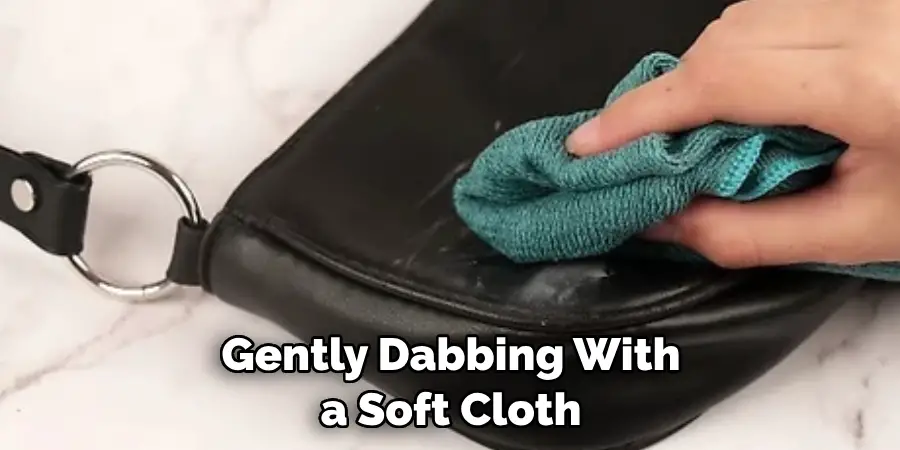 Gently Dabbing With a Soft Cloth