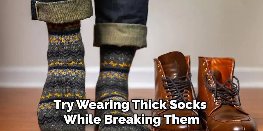 Try Wearing Thick Socks 
While Breaking Them