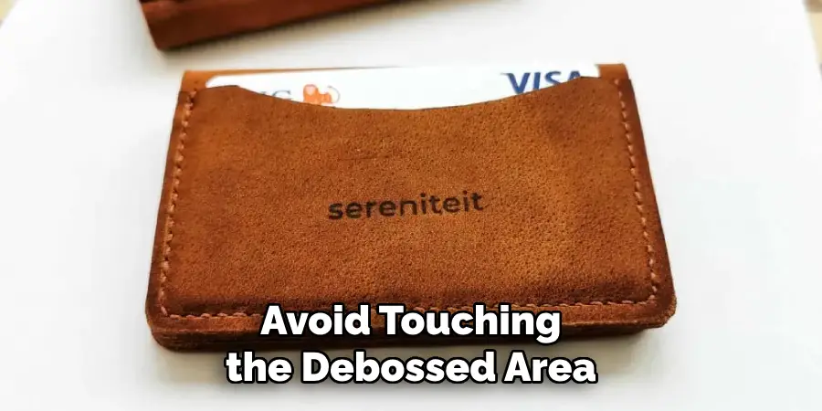 Avoid Touching the Debossed Area
