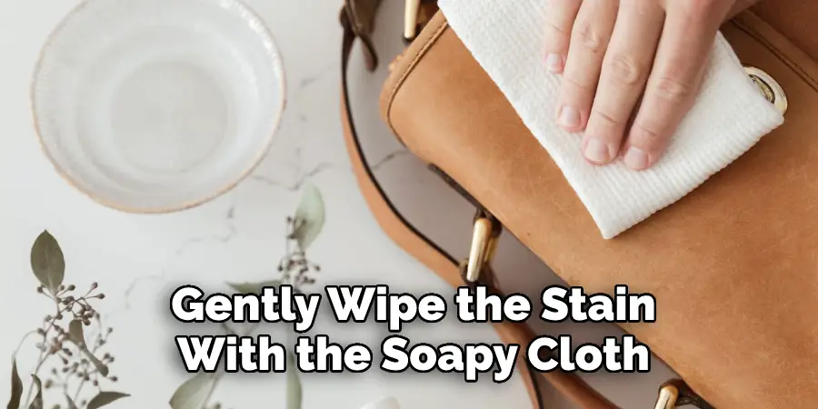 Gently Wipe the Stain With the Soapy Cloth