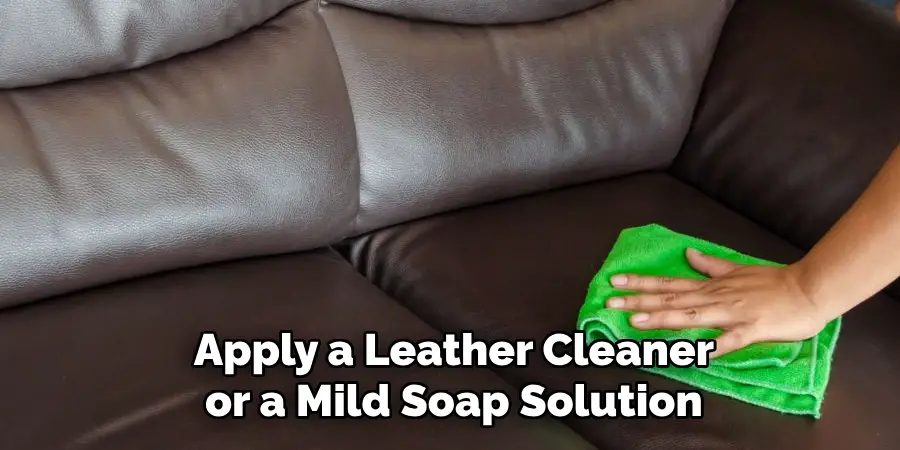 Apply a Leather Cleaner or a Mild Soap Solution